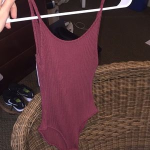 **must go** Out from under maroon bodysuit